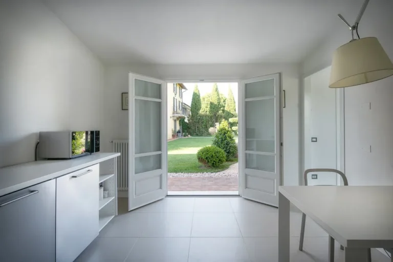 Dining corner of the apartment with French doors opening onto the garden