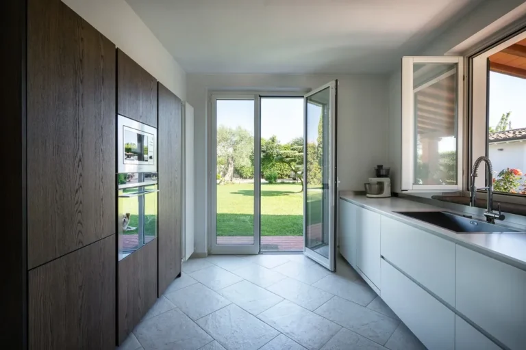 Kitchen with oak units and a glass door open onto the garden
