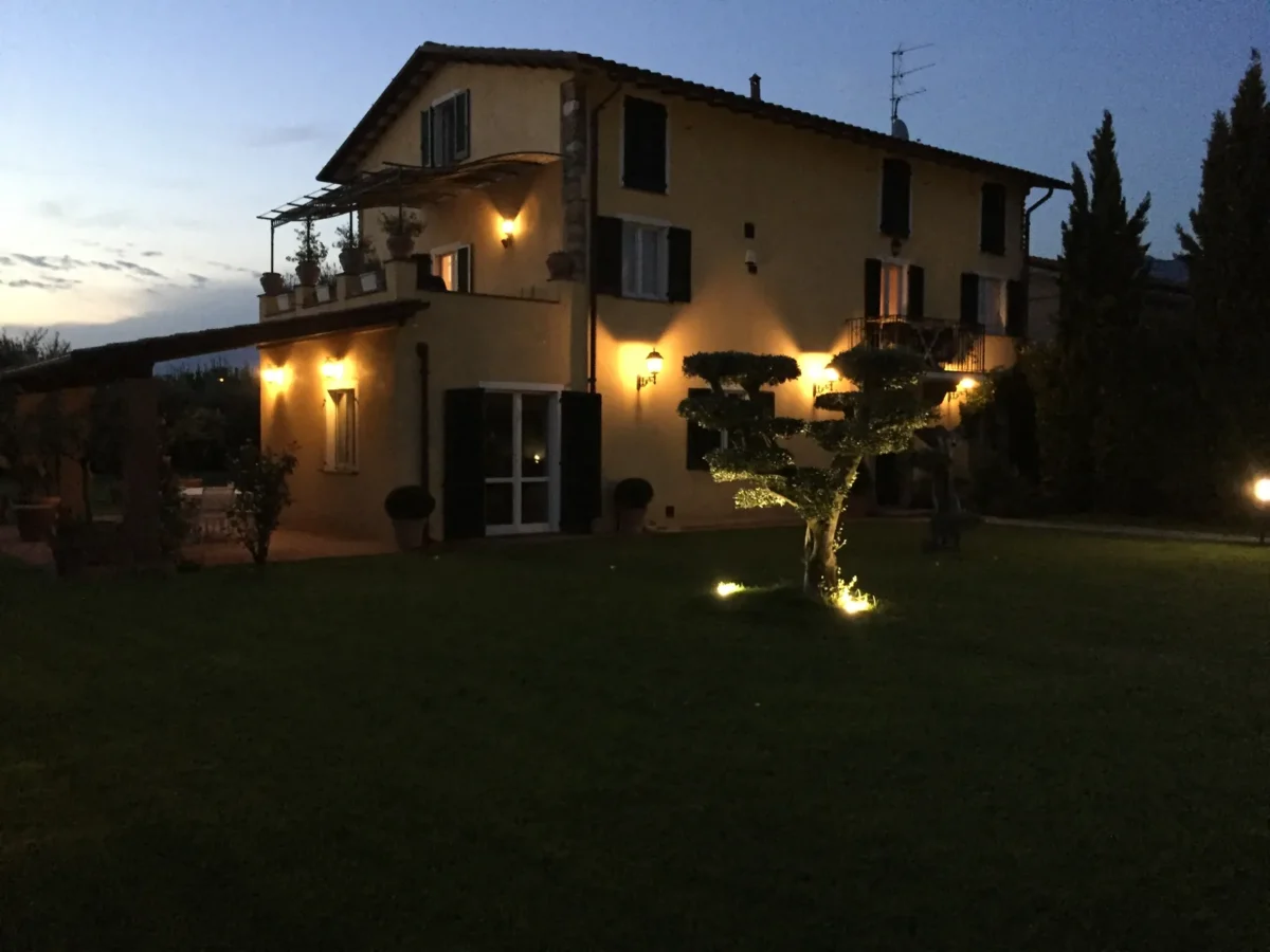 The historic villa of the Dimora Arabella holiday apartments in Pietrasanta, lit up at dusk